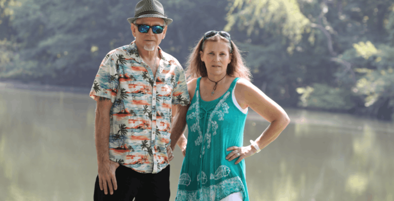 Todd and Shari looking serious in front of a placid lake